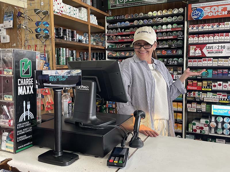 A happy operator behind the counter at Kwik Shop, on Insight POS